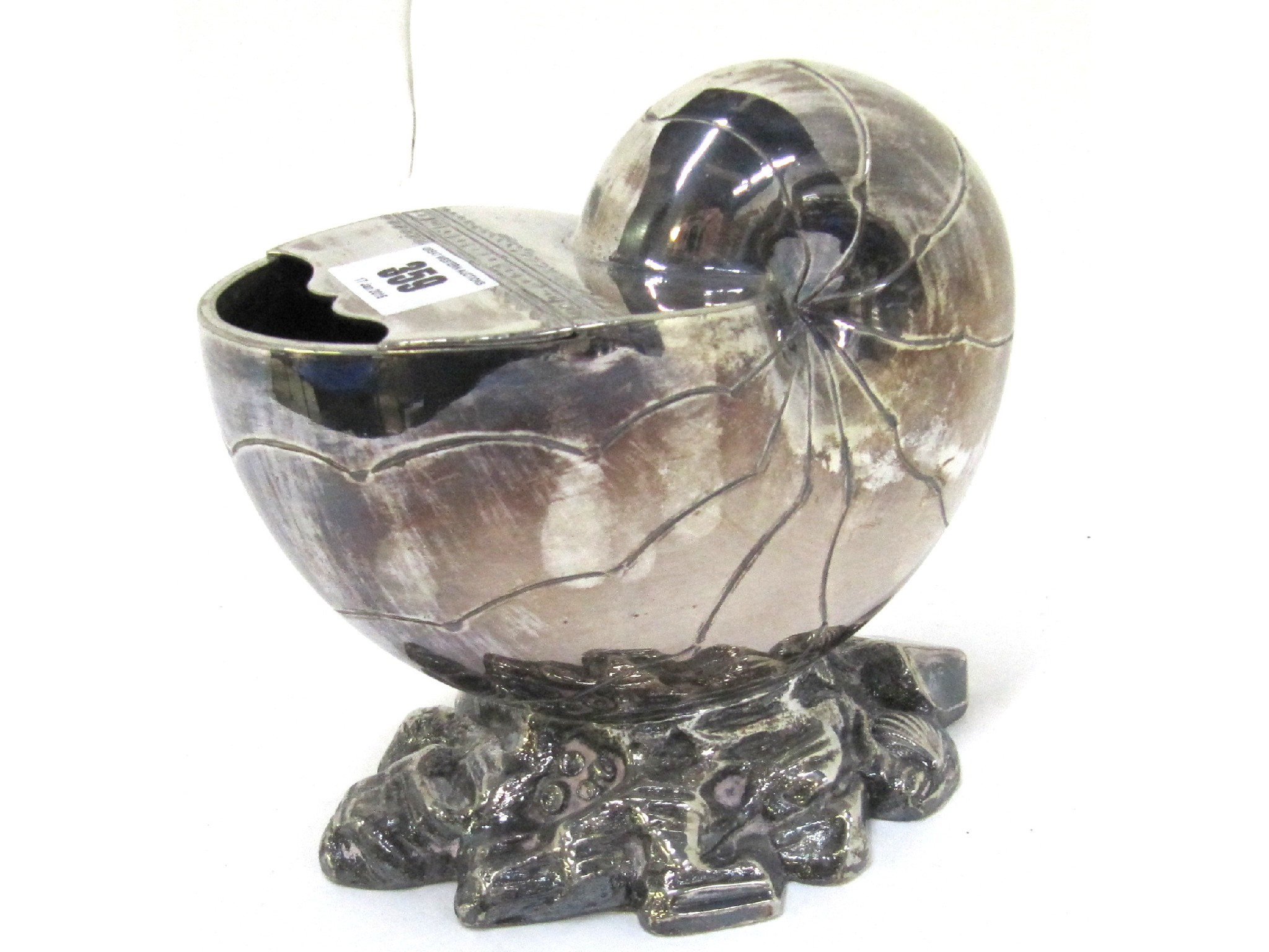 A silver plated shell shaped spoon warmer