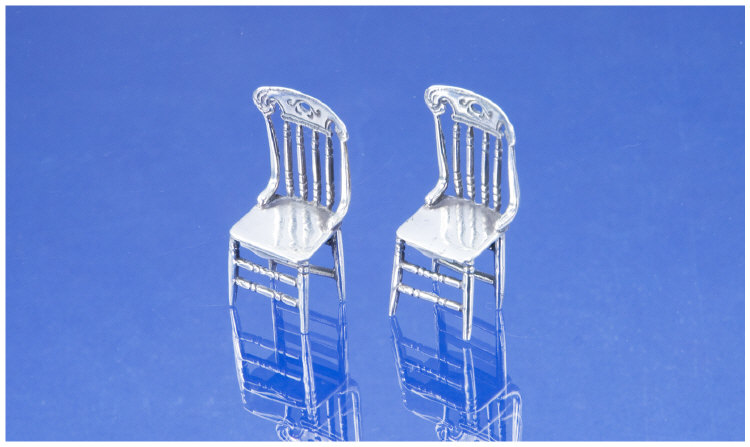 A Pair of Miniature Novelty Silver Spindle Back Chairs Well