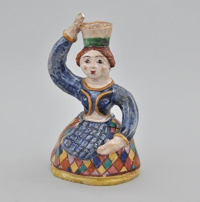 An Italian Glazed Ceramic Figure of a Woman The hand