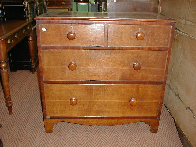 A Victorian cross banded oak and mahogany chest with knob