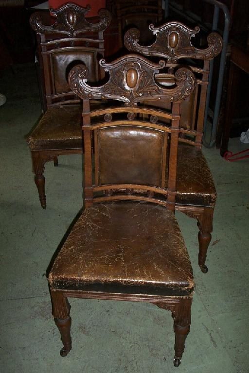 A set of eight oak dining chairs in an Art