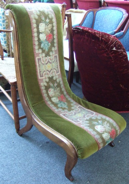 A Victorian walnut nuring chair with S scroll seat and