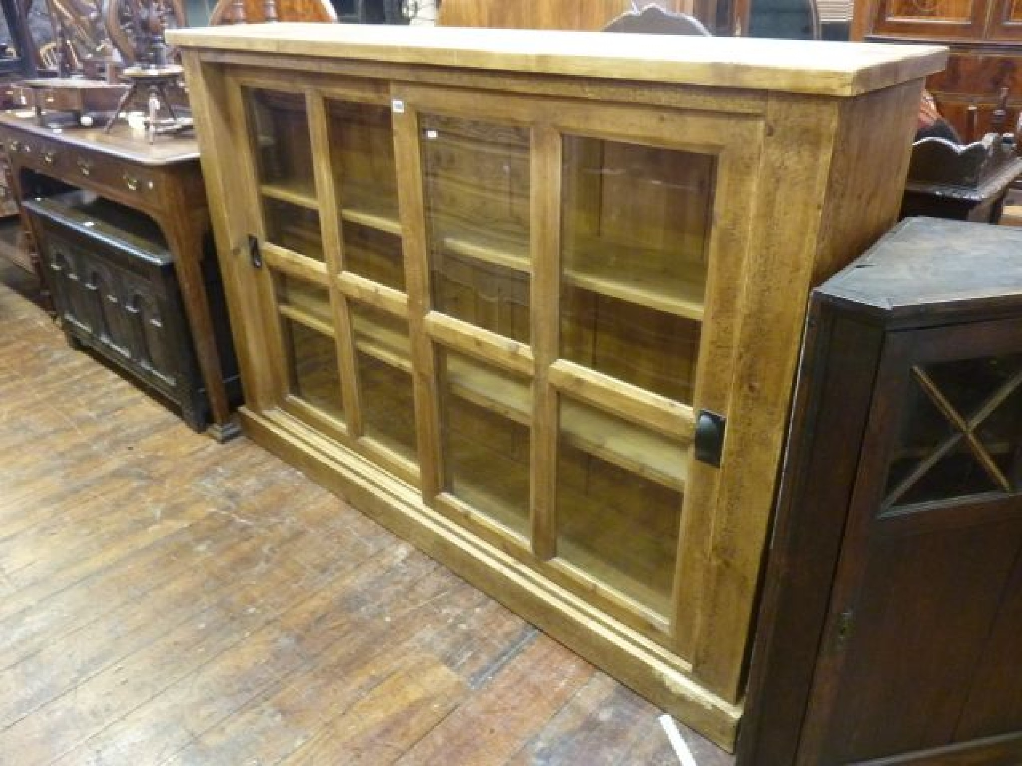 A reclaimed pine bookcase display cabinet enclosed by two glazed