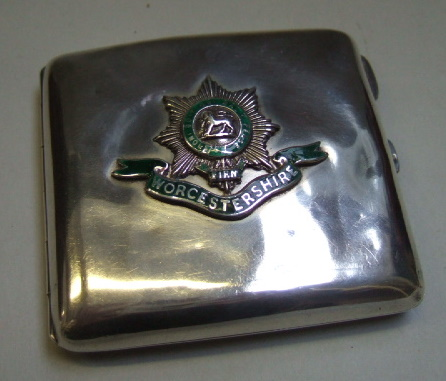 A silver rectangular presentation cigarette case the front applied with
