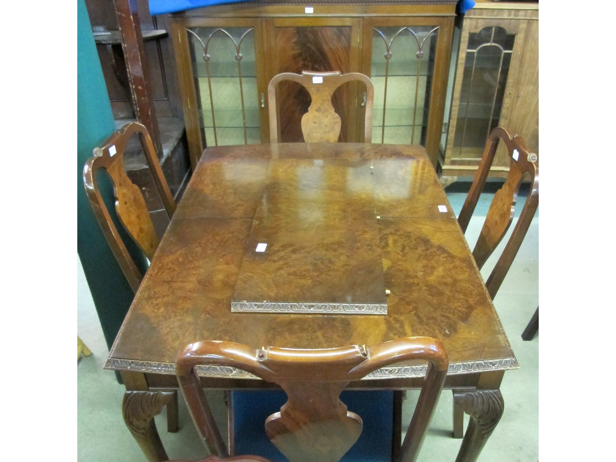 A 20th Century extending walnut dining table and four chairs