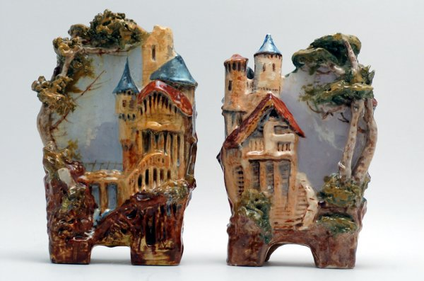 Two Majolica ceramic vases each handpainted with raised buildings and