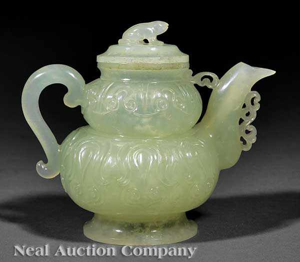 A Chinese Carved Celadon Jade Covered Teapot the relief carved