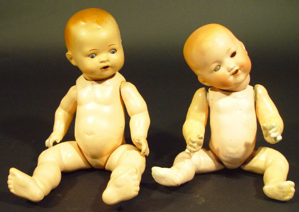 Two German bisque headed dolls each with open close glass