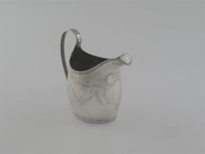 A George III engraved oval cream jug with reeded borders