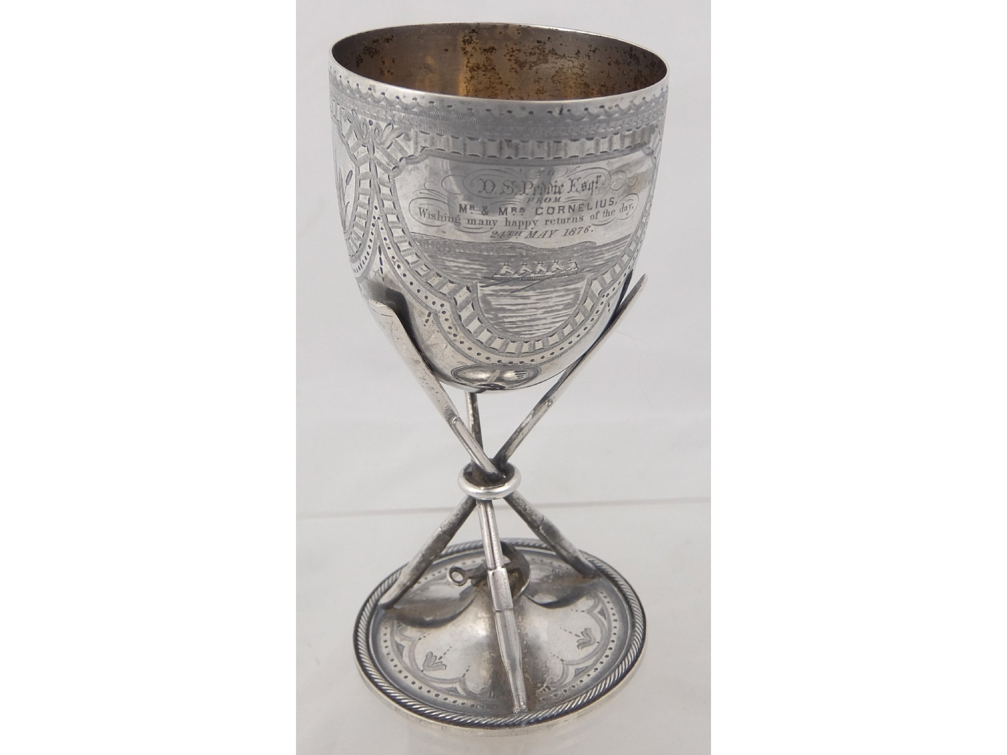 A white metal goblet with rowing and sailing motifthe tapering