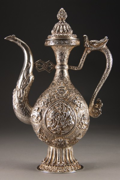 Dragon form handle and spout highly decorated with repouss figures