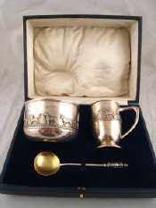 A boxed silver christening set comprising porringer spoon and mug