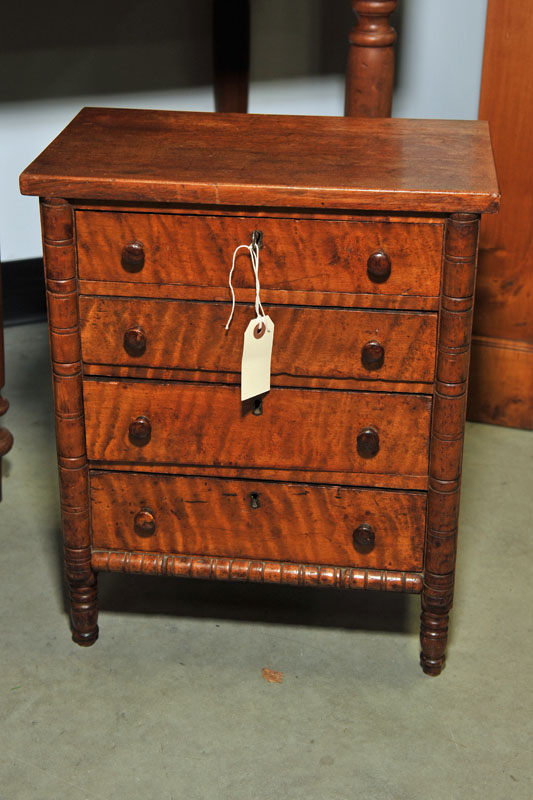 DIMINUTIVE CHEST OF DRAWERS Walnut having ring turned columns four