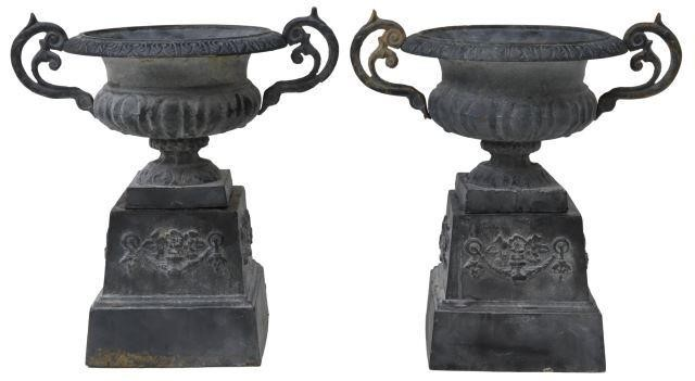 pair Large cast iron garden urns having patterned rim dual