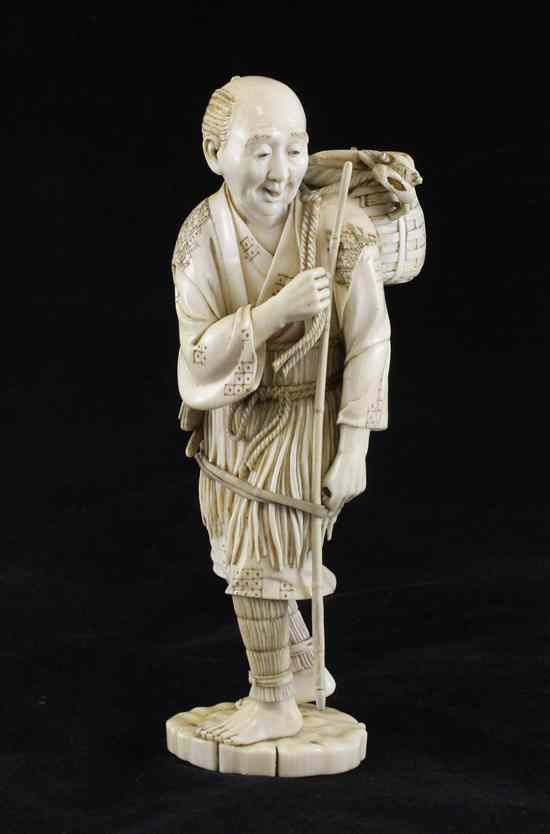 A fine Japanese ivory figure of a standing fisherman Meiji