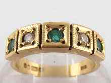A 9 carat gold five stone emerald and diamond ring