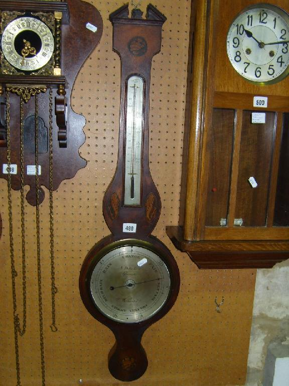 A Georgian mahogany wheel barometer with shell inlaid detail silvered