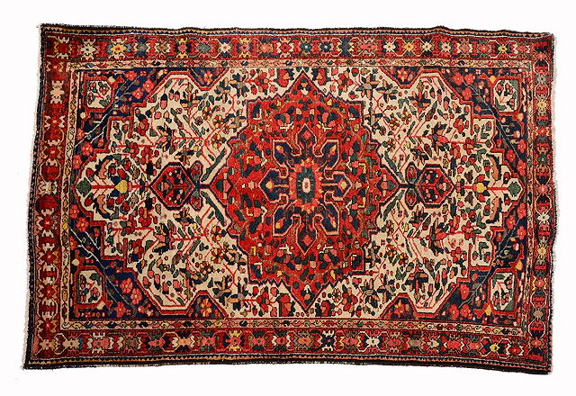 A BAKHTIARI WHITE GROUND RUG with a central rose medallion