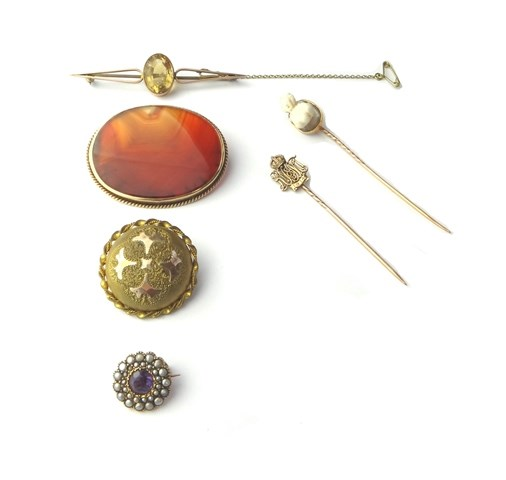 A gold mounted banded agate cameo set stick pin carved