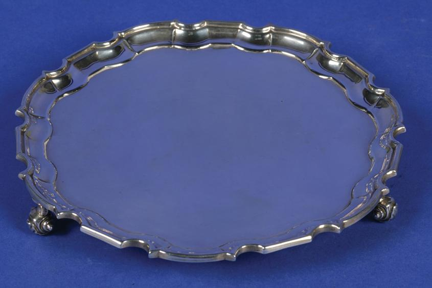 A GEORGE V WAITER of shaped circular form with a