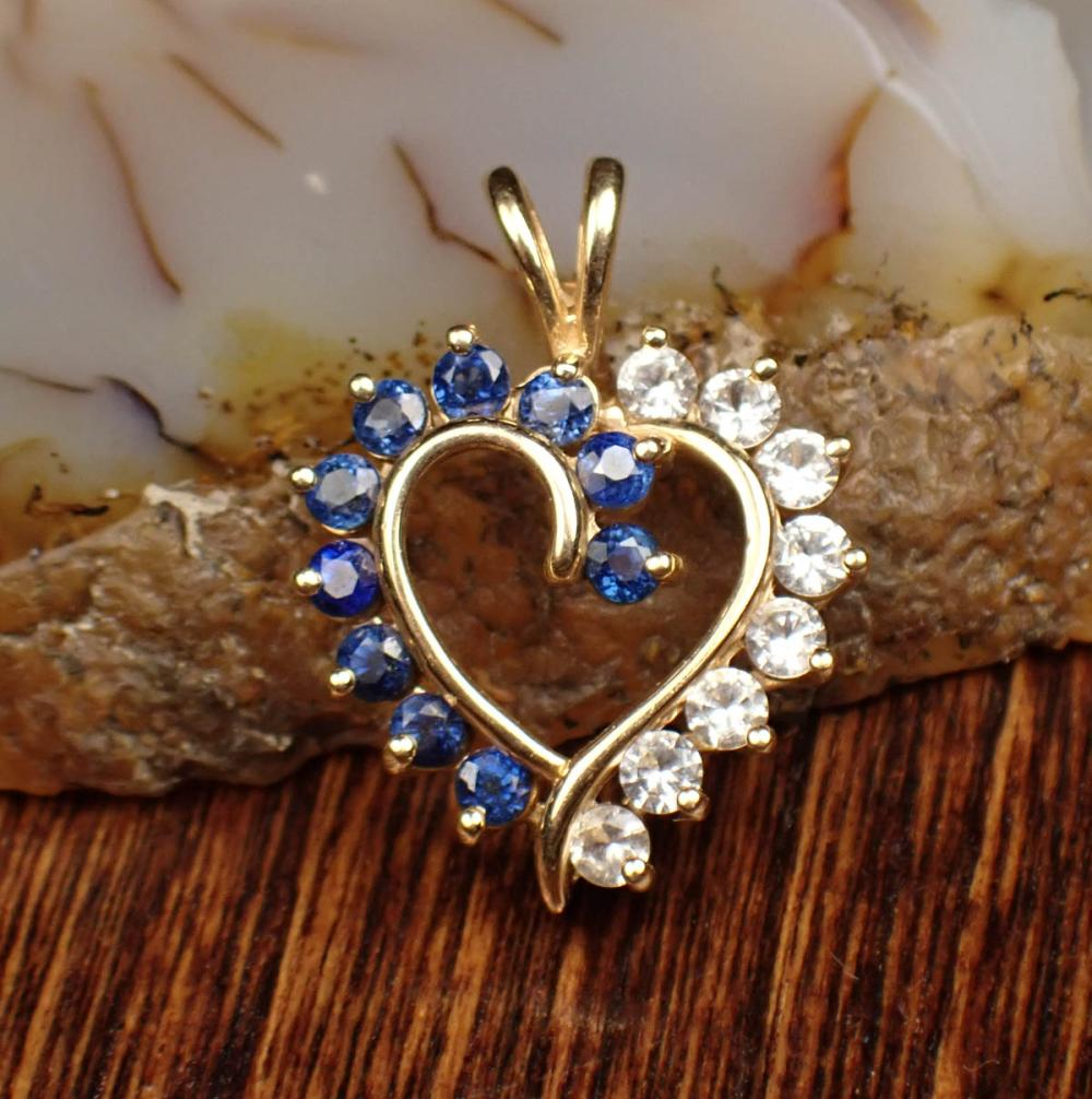 BLUE AND WHITE SAPPHIRE AND FOURTEEN KARAT GOLD PENDANT The
