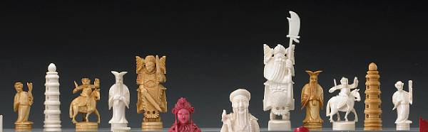 A small tinted ivory chess set with a foldable chess