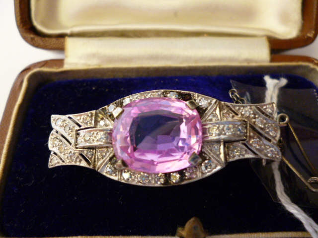 A DIAMOND BROOCH of shaped oblong form centred by an