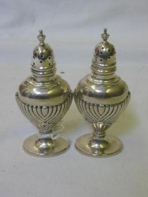 A PAIR OF SILVER PEPPERS of oval urn form with