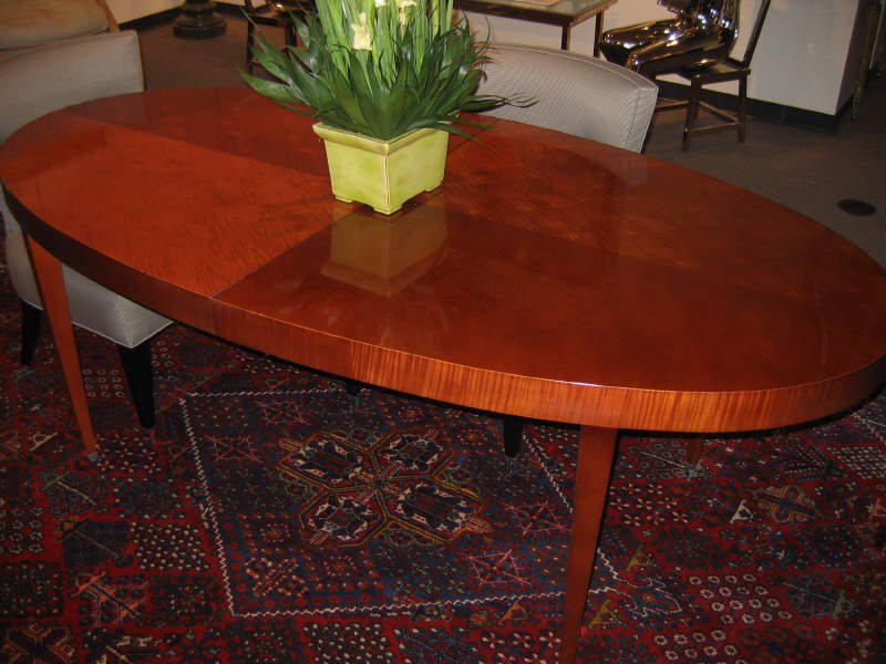 BAKER FURNITURE Mahogany oval dining table raised on tapering square