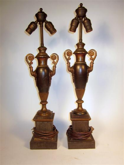 Pair of Continental patinated and parcel gilt metal urnsClassical form