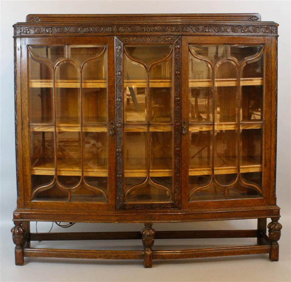 ENGLISH RENAISSANCE REVIVAL CARVED OAK BOOKCASE having a backsplash with
