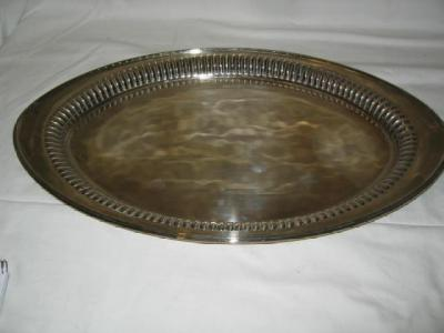 A LATE VICTORIAN TRAY of oval form the flared rim