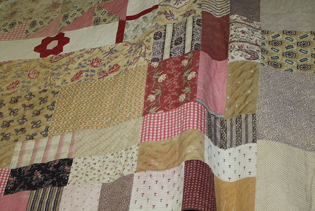 A LARGE PATCHWORK QUILT the central panel having a design