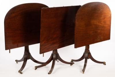 A mahogany two pillar dining table fitted an extra leaf