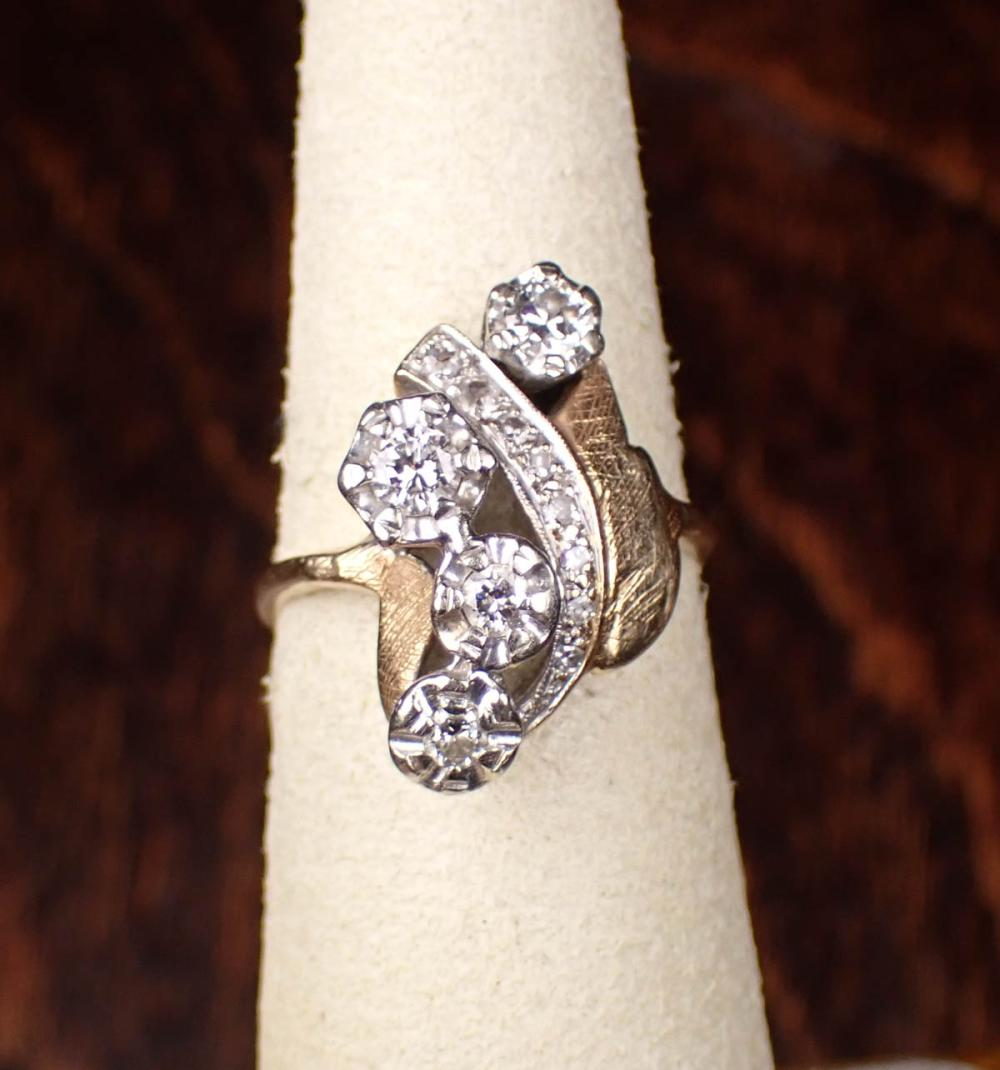 DIAMOND AND FOURTEEN KARAT TWO TONE GOLD RING The yellow