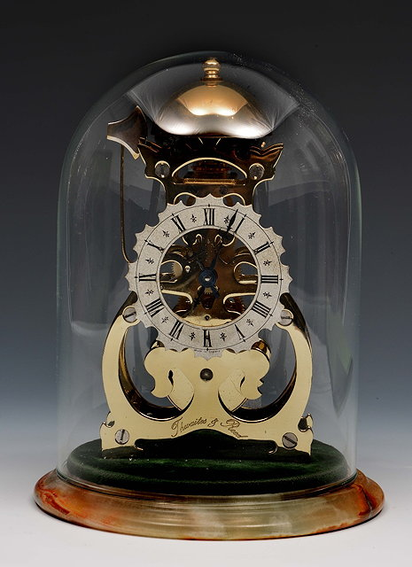 A Thwaites Reed brass skeleton clockwith silvered Roman chapter ring