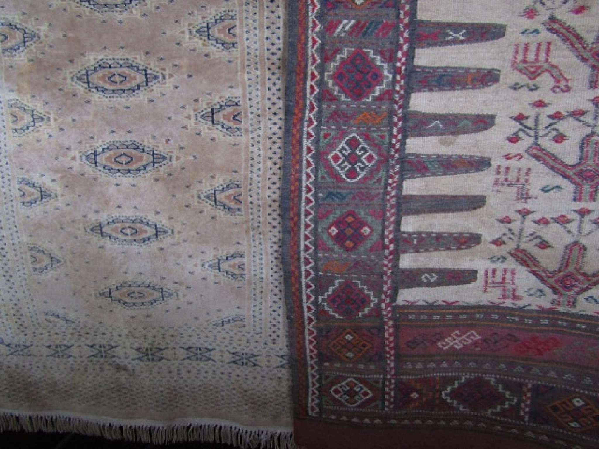 An eastern wool work rug with central cream field decorated