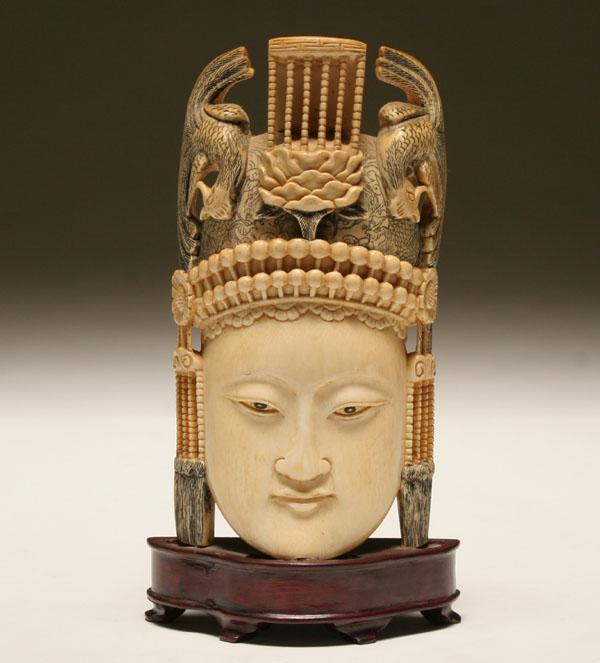 Carved ivory tusk of a Buddha head the crown with