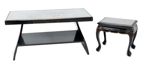 A heavily carved Chinese coffee table decorated with a scene