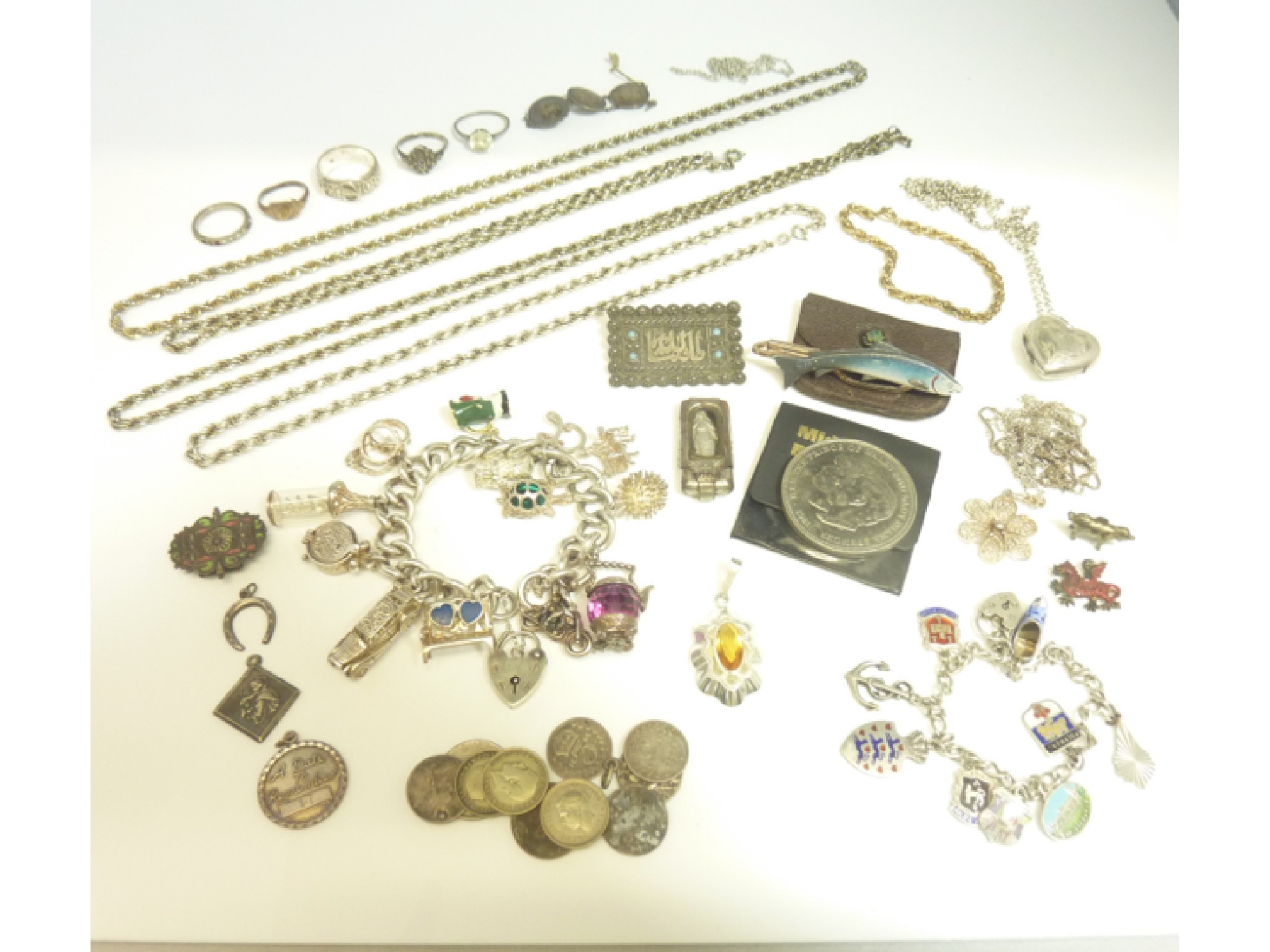 A sterling silver charm bracelet with heart shaped padlock clasp