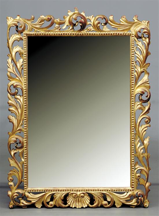 Continental carved giltwood looking glass scrolling foliage and shells enclosing