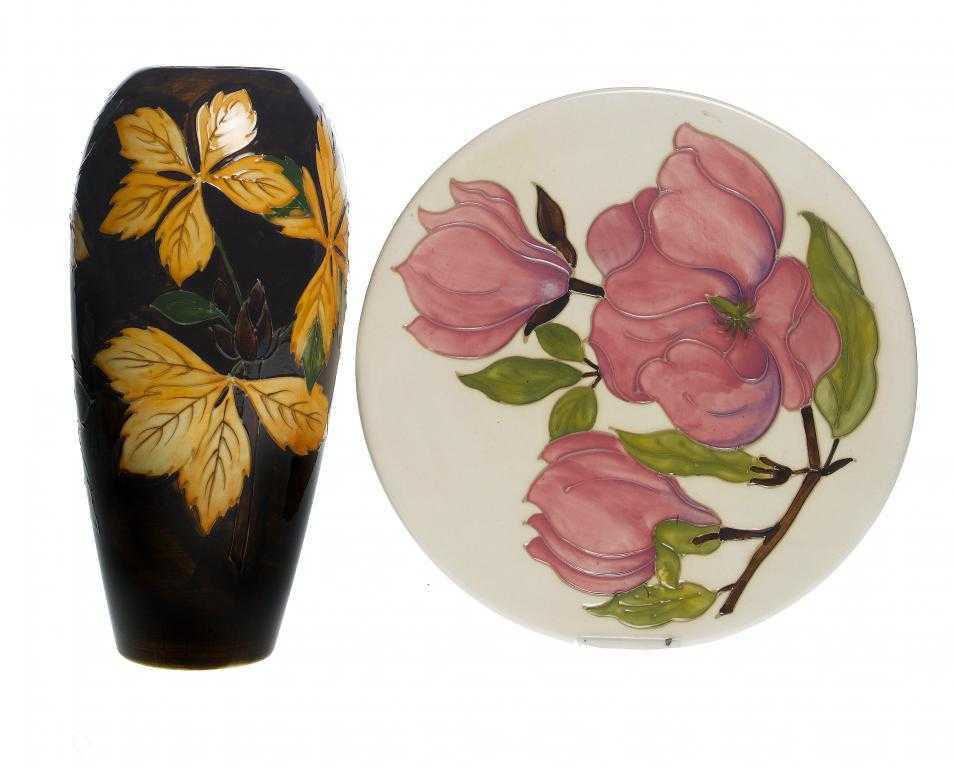 A MOORCROFT CHESTNUT LEAVES VASE AND A MAGNOLIA PATTERN PLATE