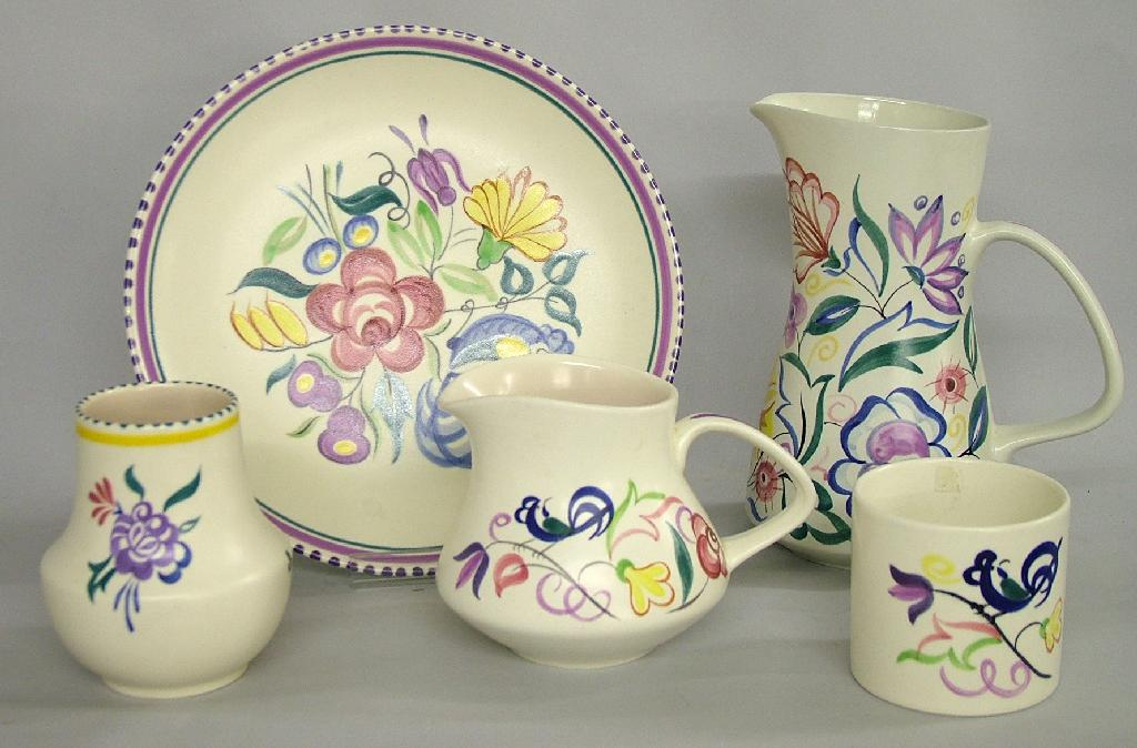 Five pieces of Poole Pottery comprising a circular plate two