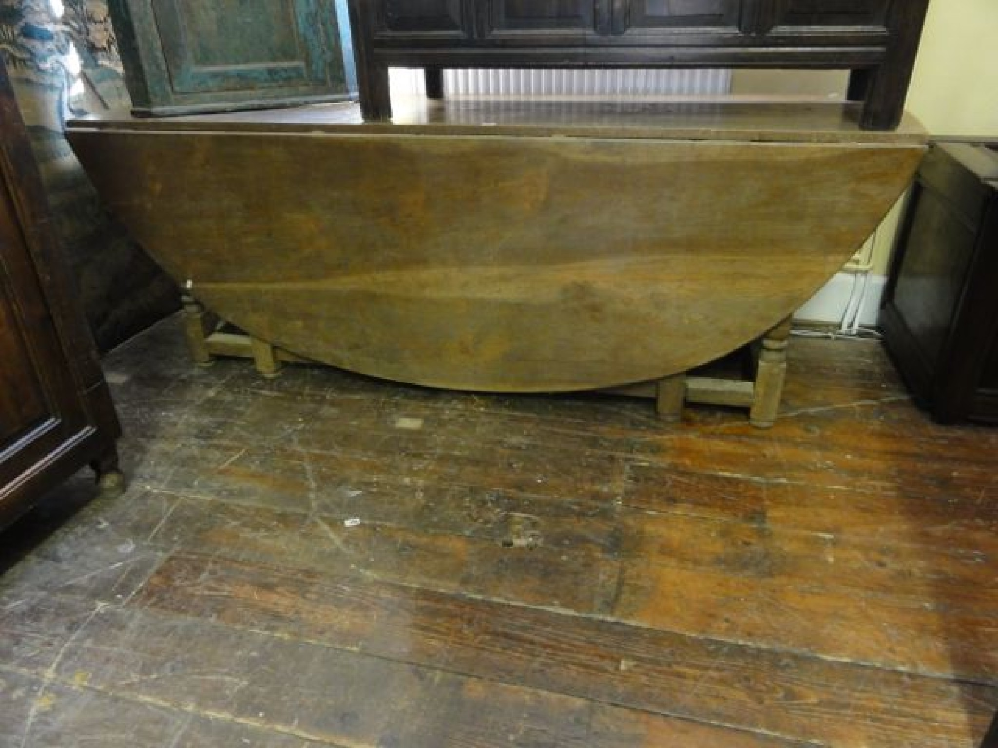 A substantial old English style gateleg dining table the oval