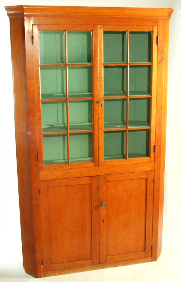 A softwood double door one piece built in corner cupboard