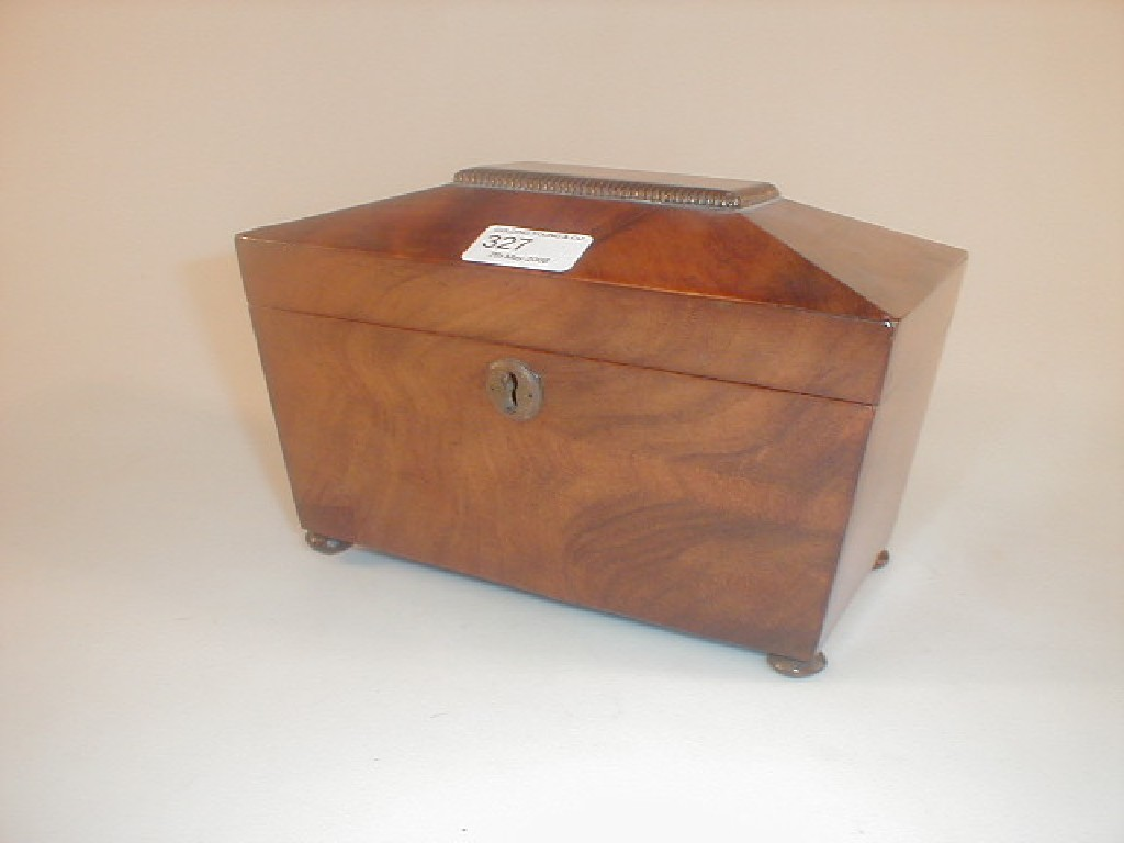 A Regency figured mahogany sarcophagus shaped tea caddy with bun