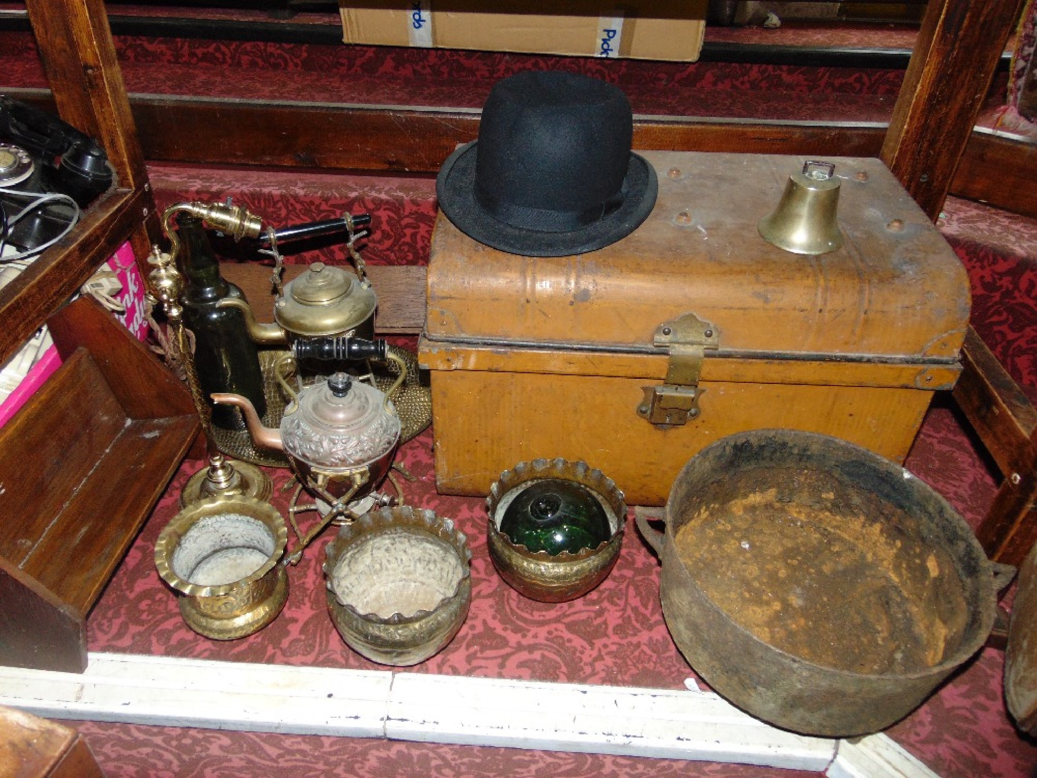 An antique tin trunk with hinged domed lid with painted