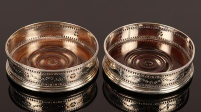 A pair of George III silver wine coasters HH London