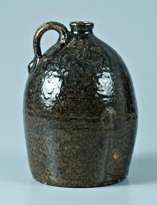W Beecham stoneware jug ovoid with medium to runny olive