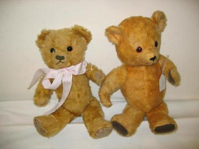 A gold plush articulated teddy bear with black glass eyes